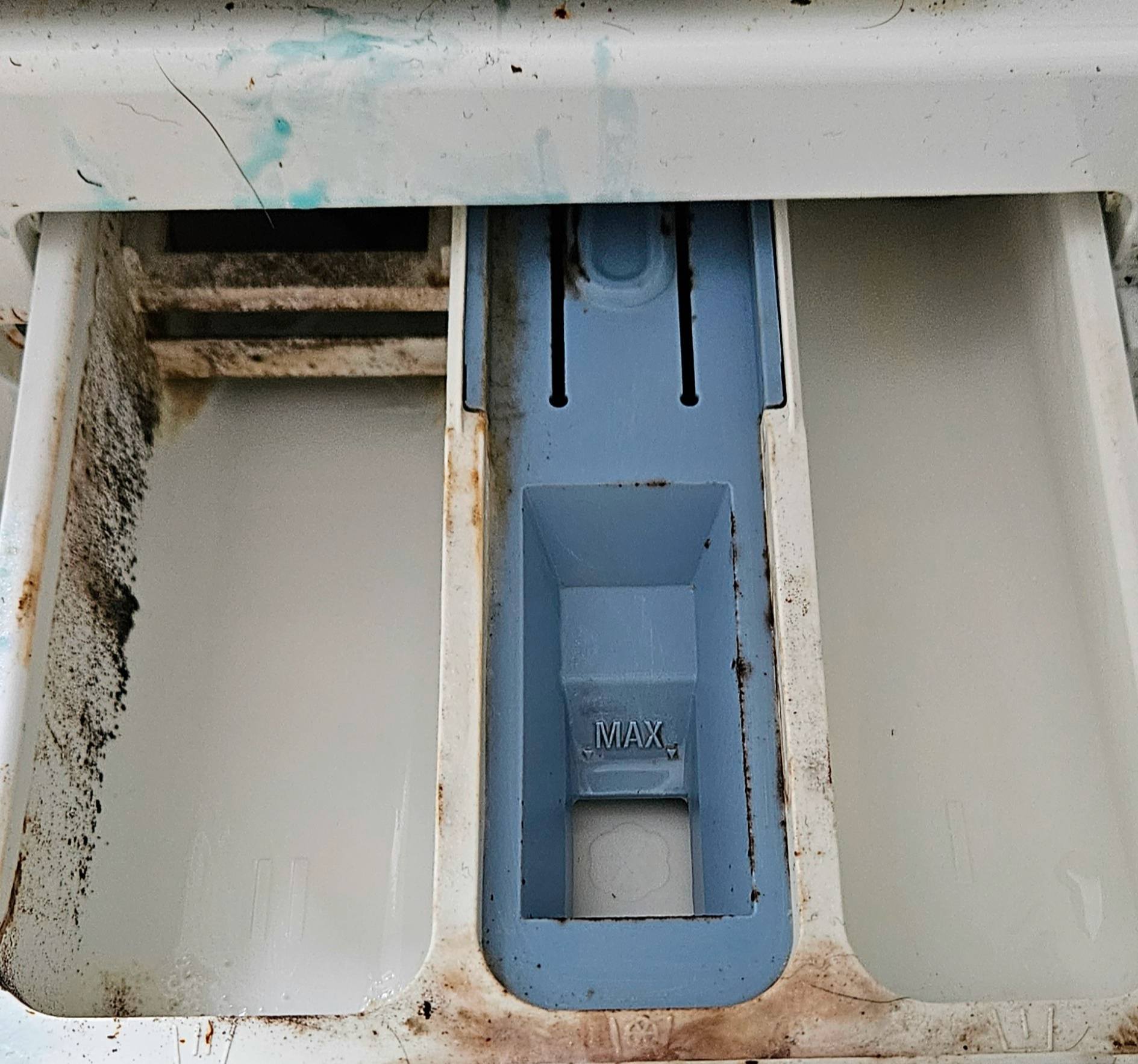 Mouldy washing machine detergent drawer before cleaning