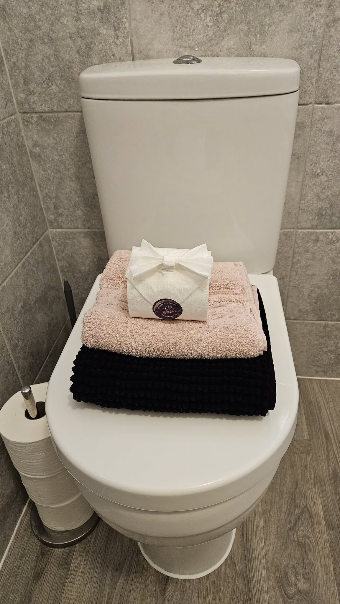 Beautifully presented bathroom with neatly folded towels and styled toilet roll